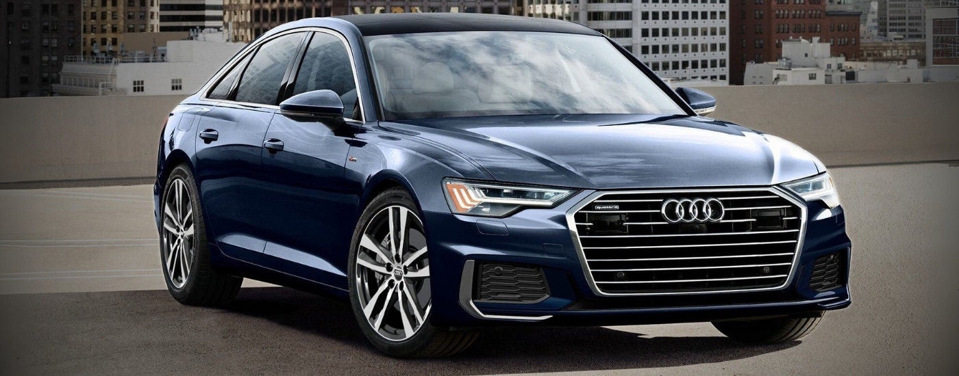 A blue 2020 used Audi A6 for sale in Roanoke on a rooftop garage.